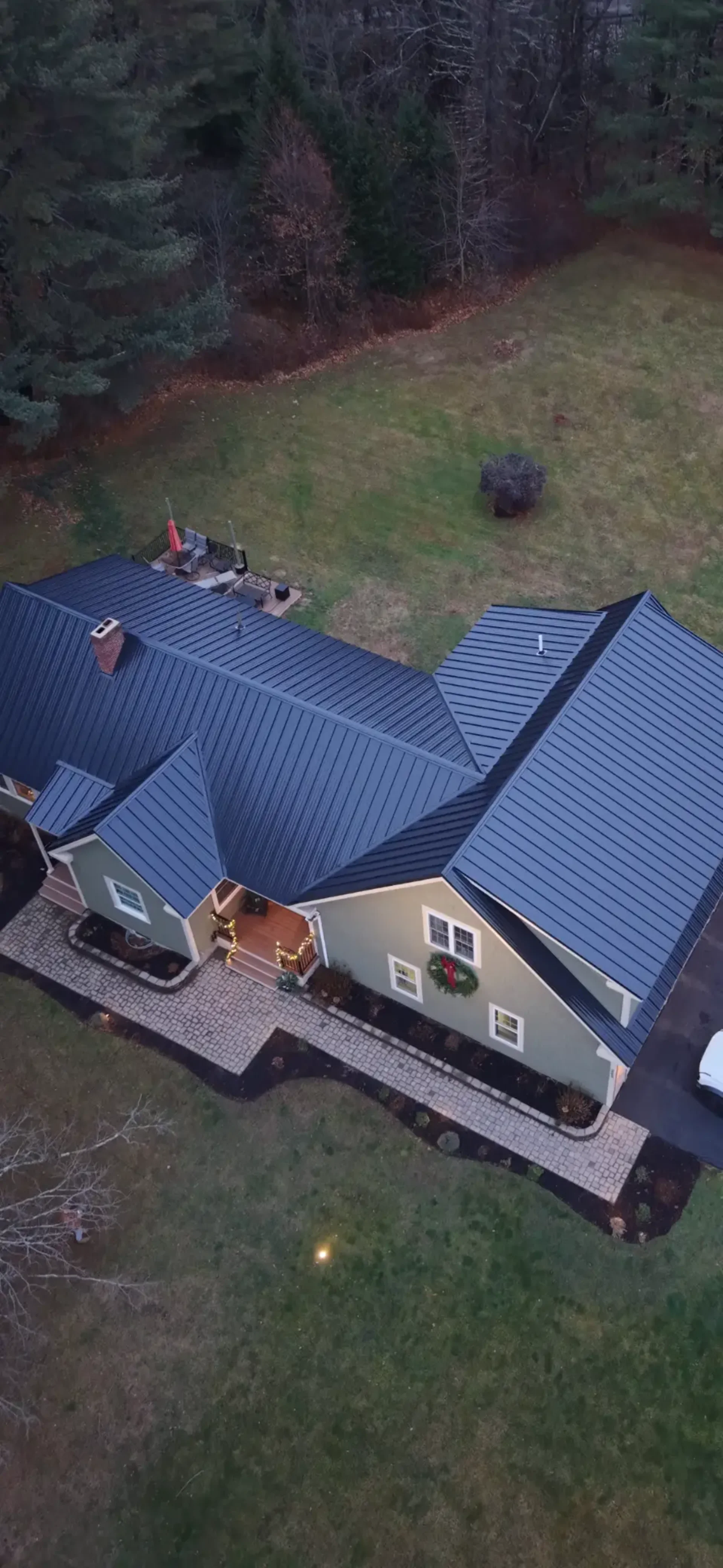 Aerial drone view of premium standing seam metal roofing installation in Cumberland Center, Maine - GraniteShield Roofing