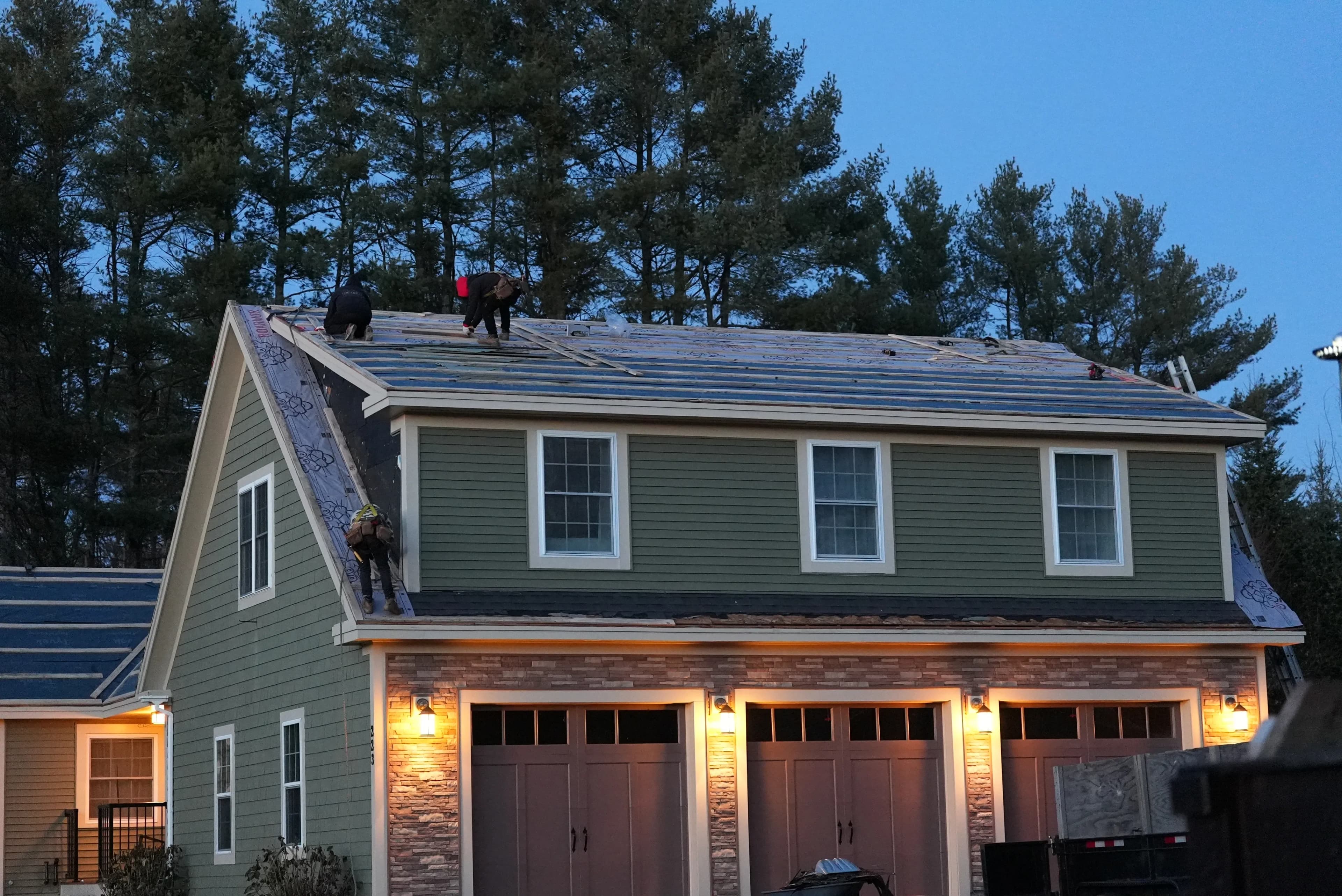 Standing seam metal roofing installation in progress with careful attention to flashing details