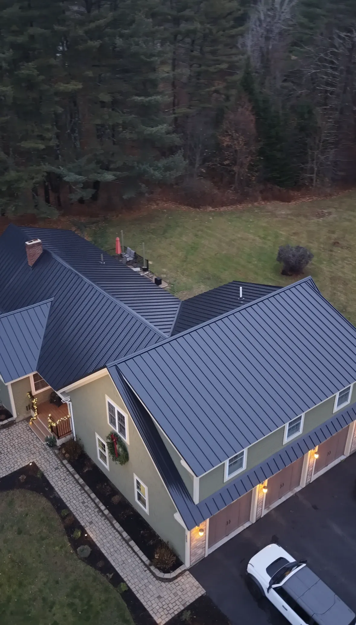 Completed standing seam metal roof installation on Southern Maine home with clean lines and professional finish