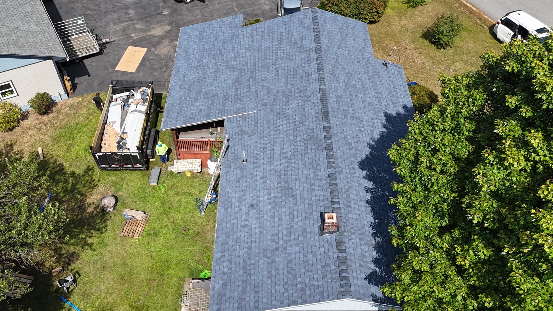 New shingle roof with professional ridge cap installation - drone photography of completed roofing project