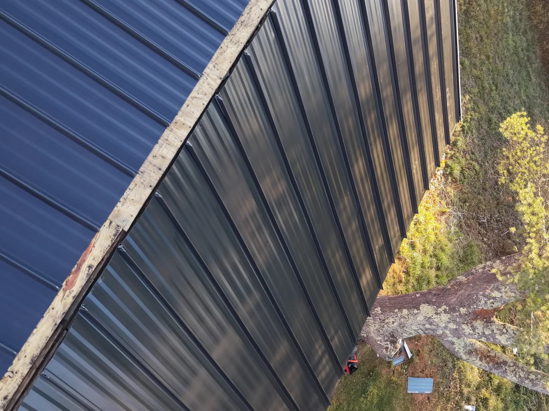 Standing seam metal roof ridge detail - professional metal roofing craftsmanship in Maine