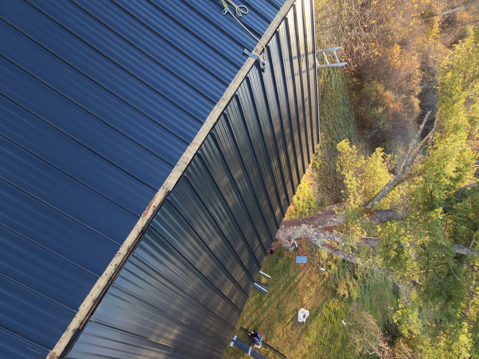 Two-tone standing seam metal roof in Maine - blue and charcoal metal roofing installation