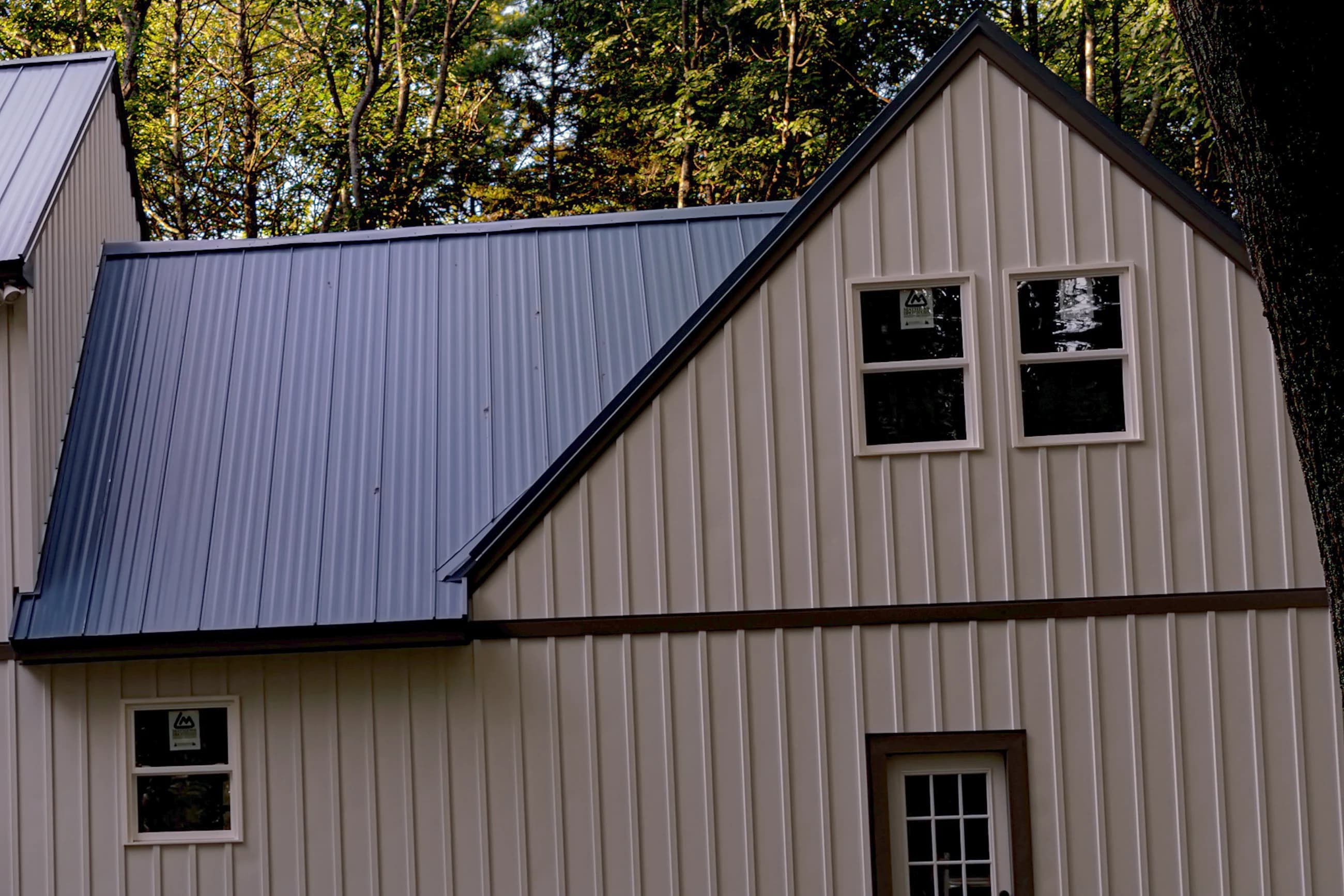 Board-and-batten metal siding installed on a home in Freeport, Maine by GraniteShield Roofing & Exteriors